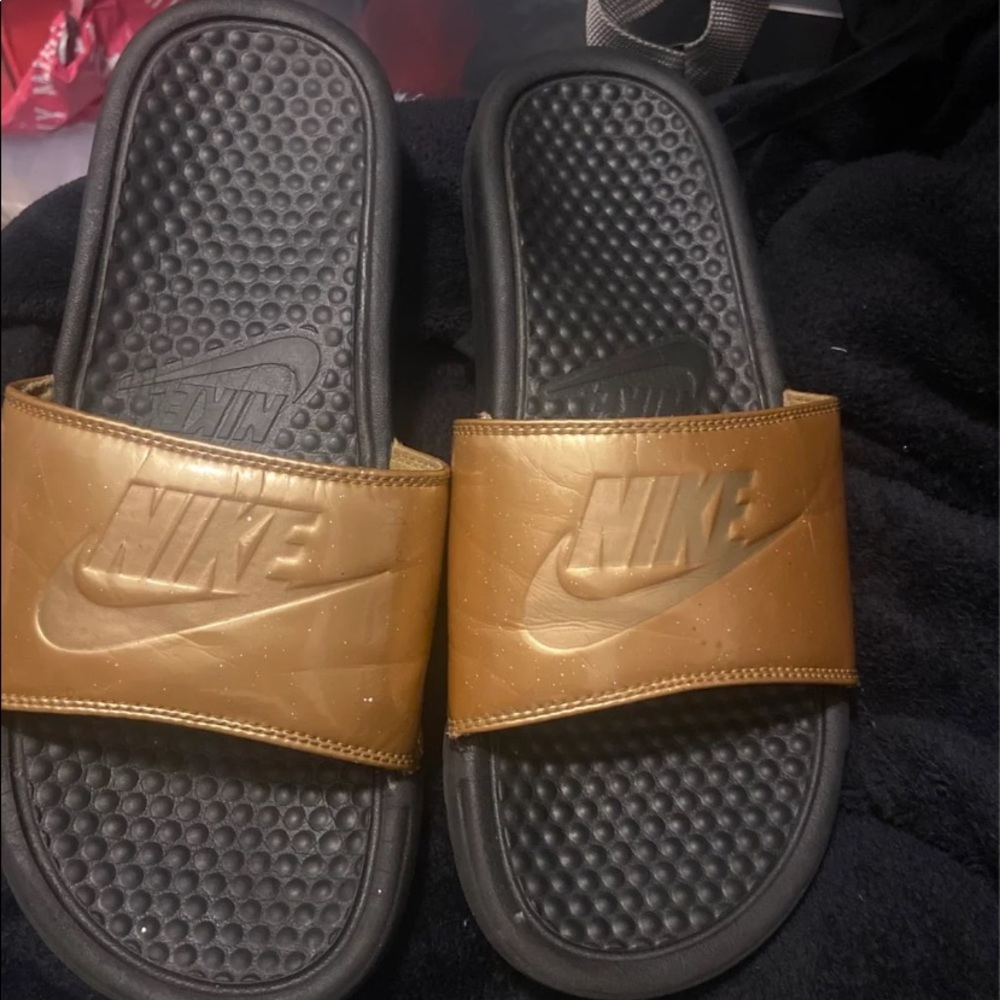 Gold Nike slides